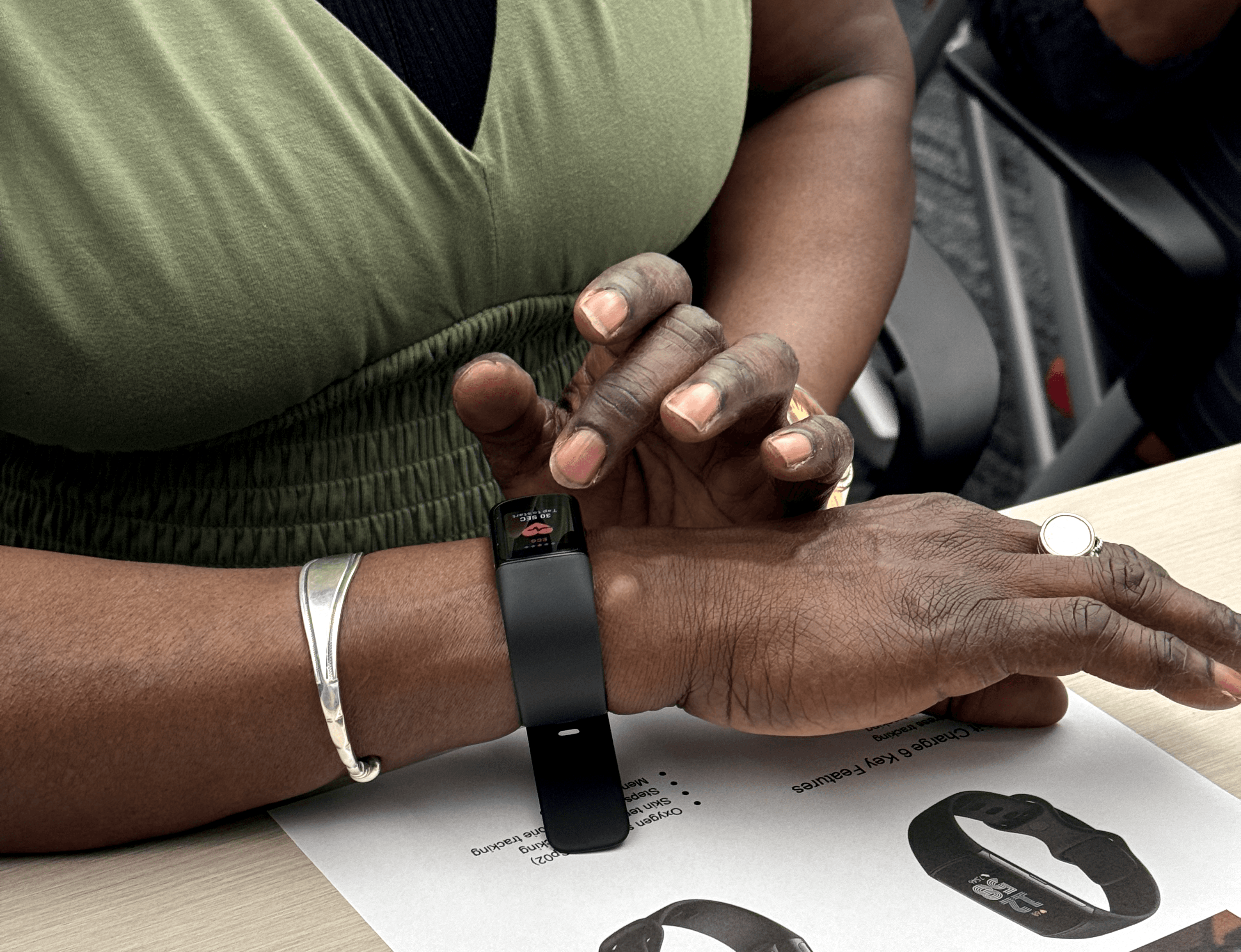 An image of a home care worker interacting with an activity tracker wristband.